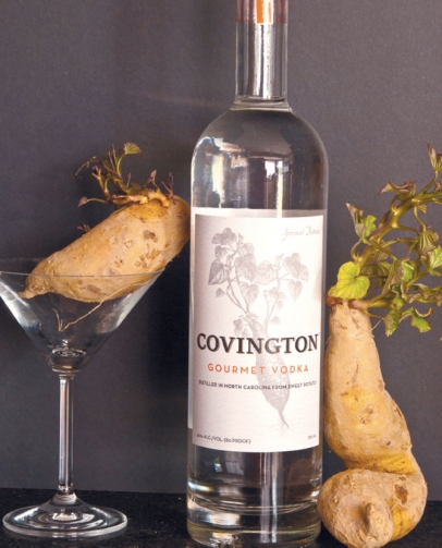 bottle of Covington Gourmet Vodka and uncooked sweet potatoes